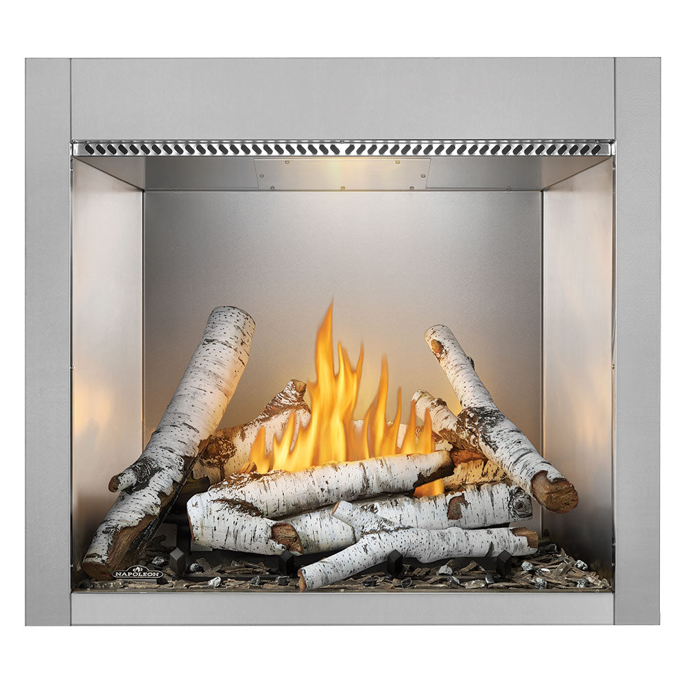 Outdoor gas fireplace with burning log set inside a silver firebox