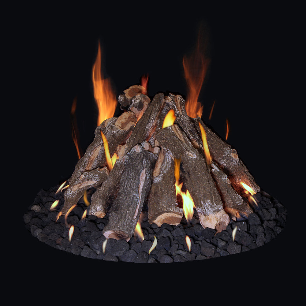 Fire pit with dark logs over black volcanic lava rock and steady orange flames