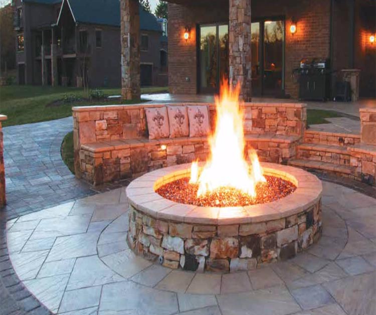 Gas fire pit burner with flame rising from circular burner opening