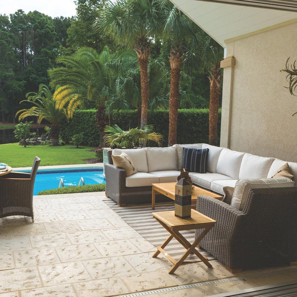 Outdoor patio loveseat with light cushions and gray wicker frame