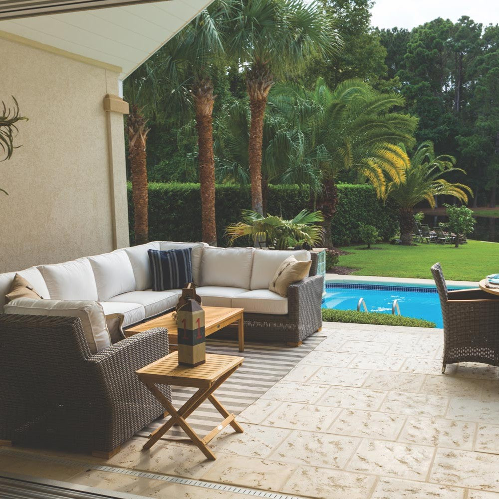Outdoor chair cushion insert with light beige seat and back on woven wicker frame
