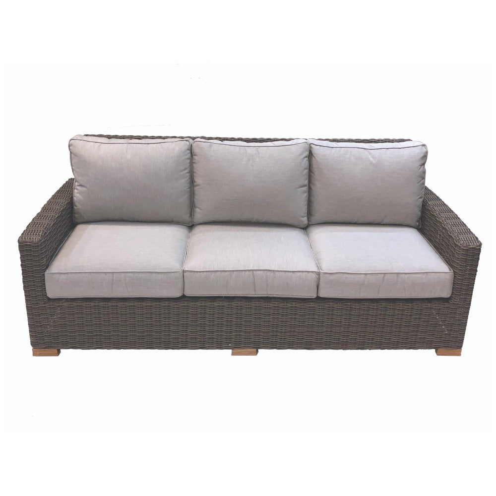 Outdoor patio sofa with gray wicker frame and light gray tufted cushions