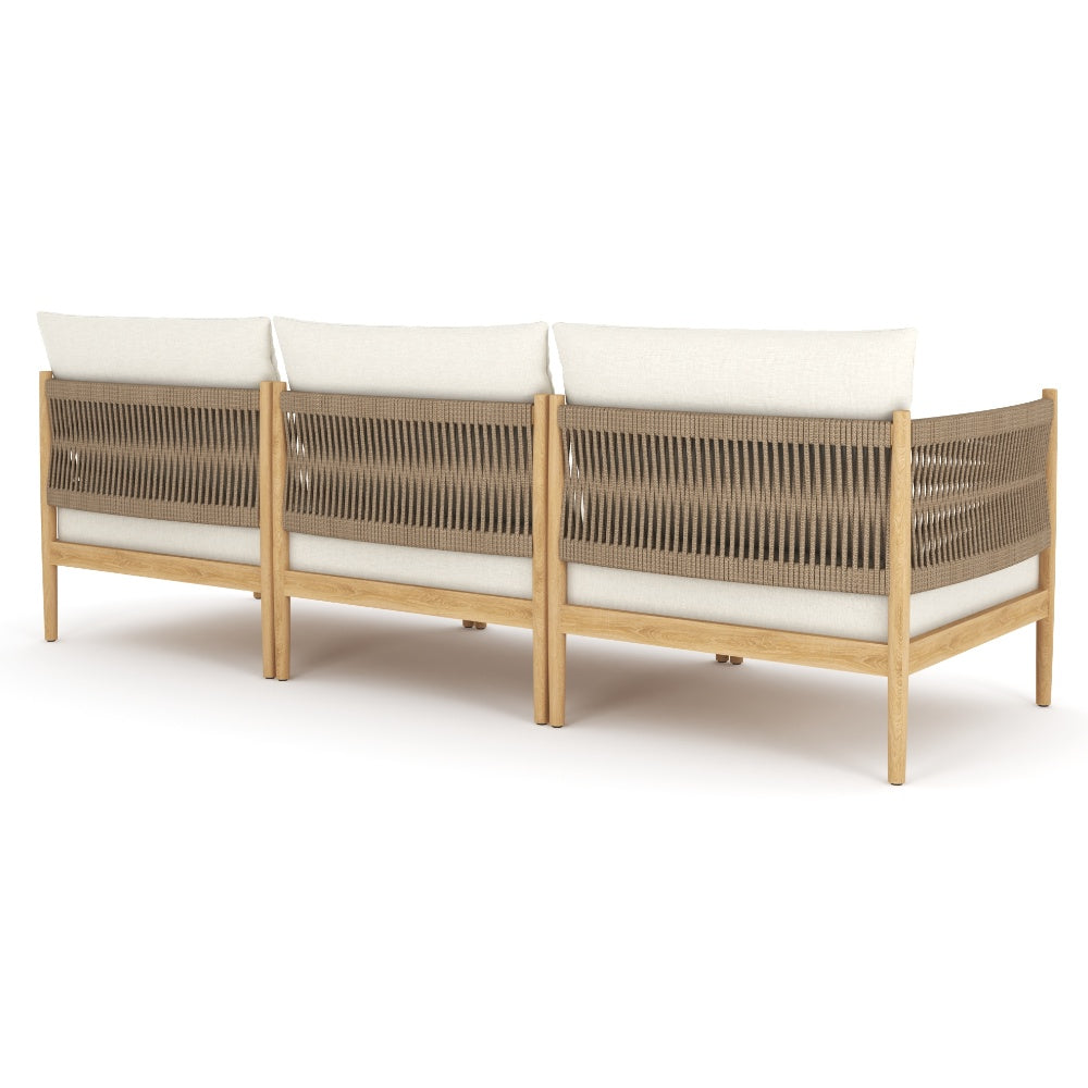 Modular sofa with three white back cushions and woven brown side panels on wood frame