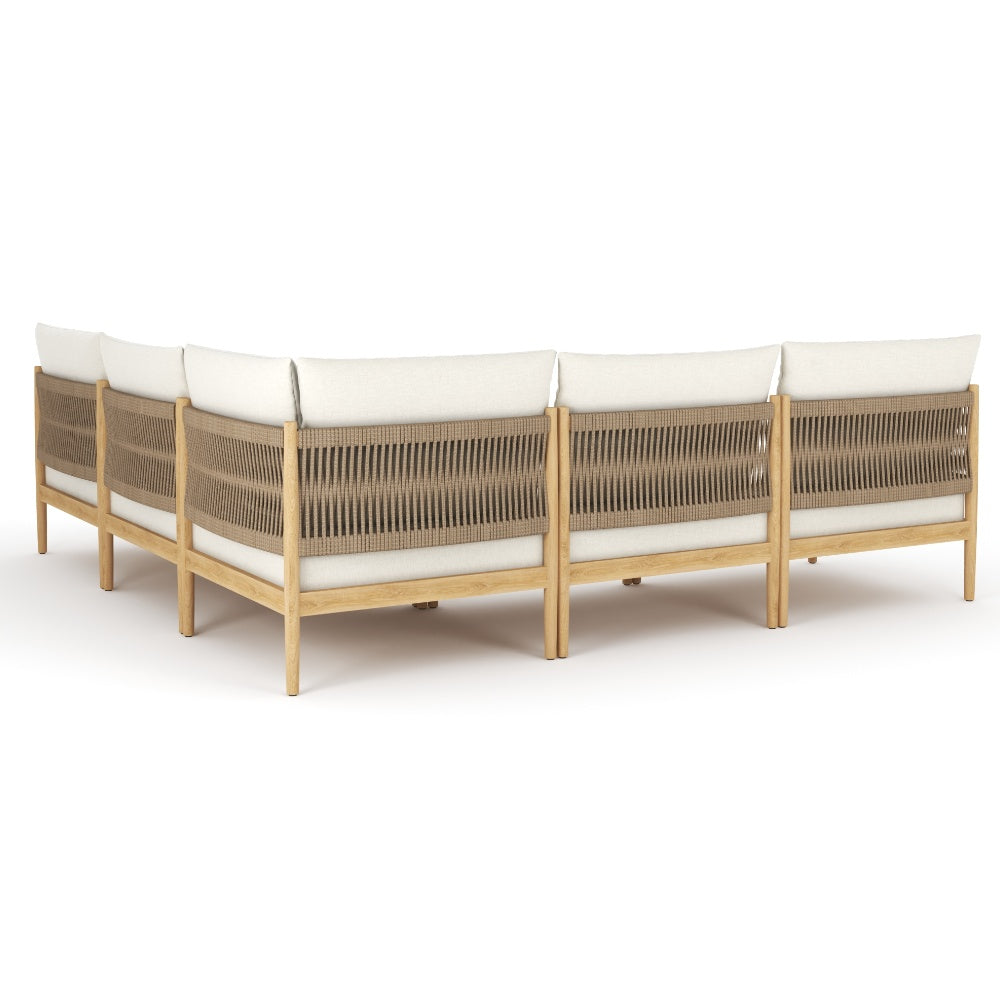Outdoor modular sectional with cream seat cushions and woven gray back panels, side view