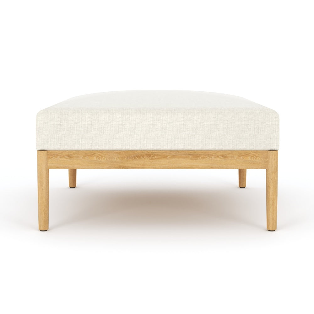 Beige upholstered square ottoman with light wood legs and flat top cushion
