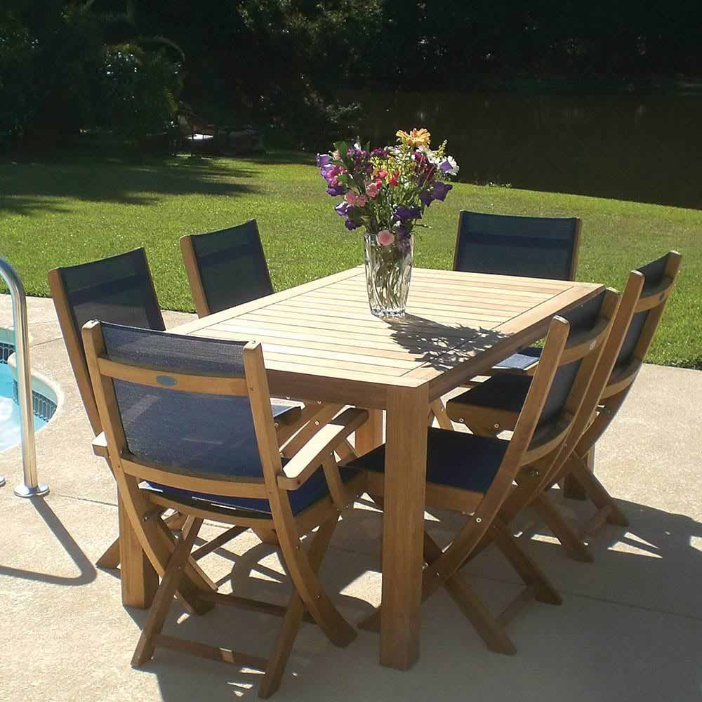 Teak folding arm chair with dark sling seat and back, outdoor poolside view