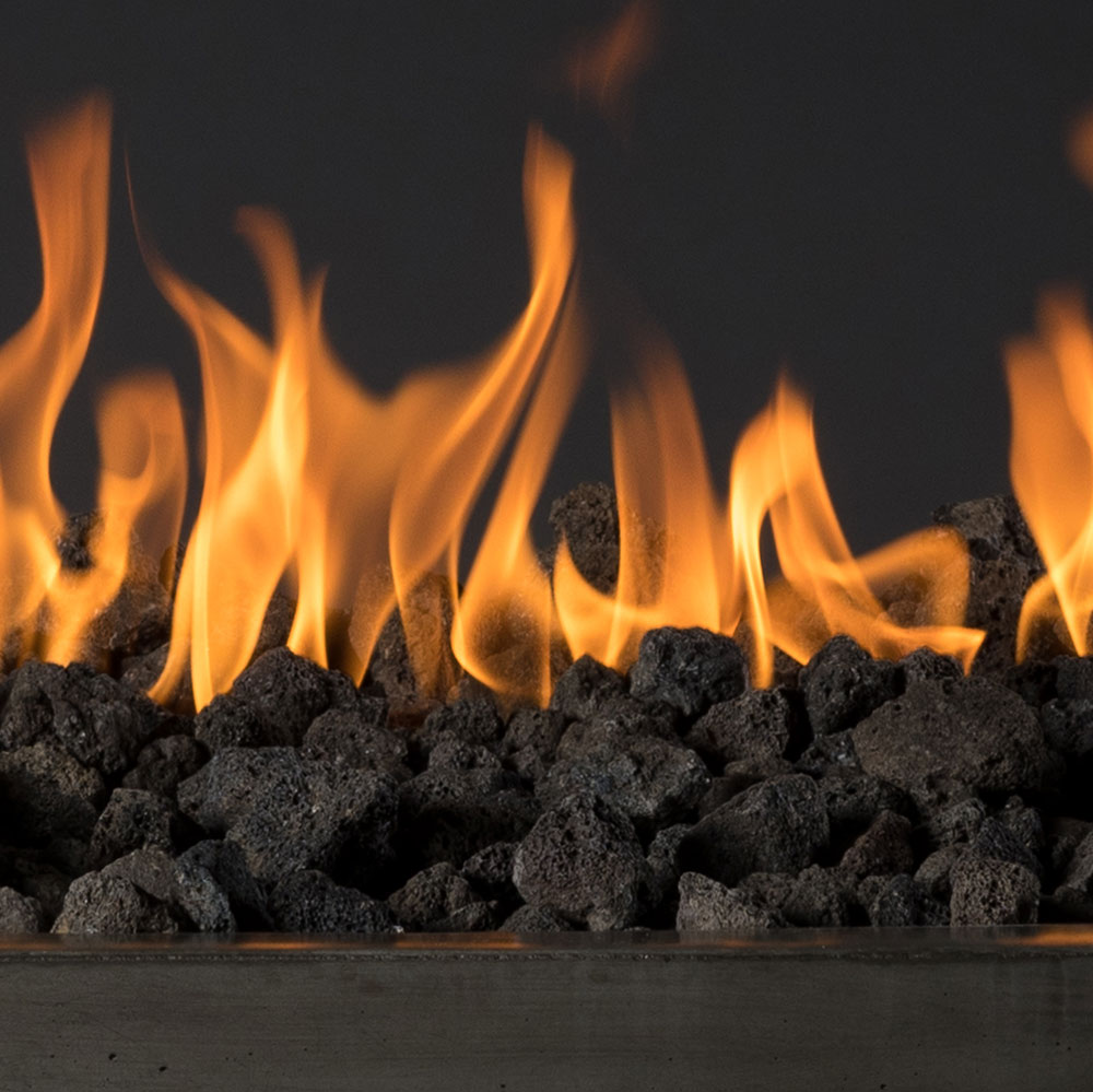 Black lava rocks piled, for landscaping or fire pits.