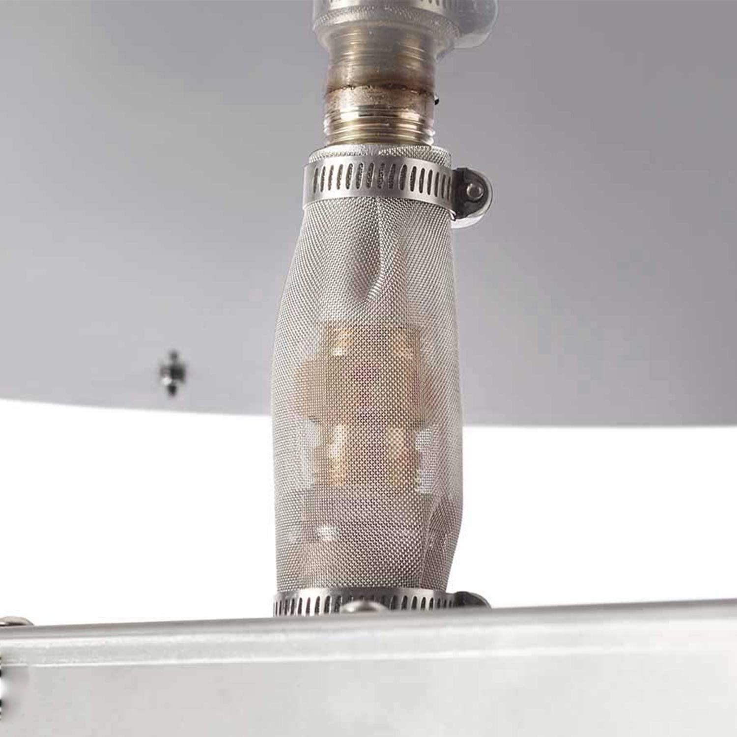 Burner mesh flame shield with brass gas fitting at the top