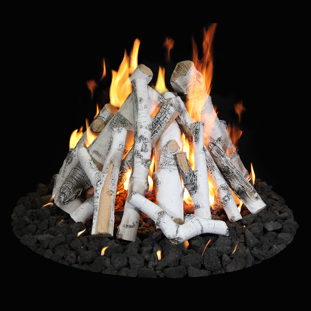 Fire pit burner with gray logs over black volcanic lava rock and open orange flames