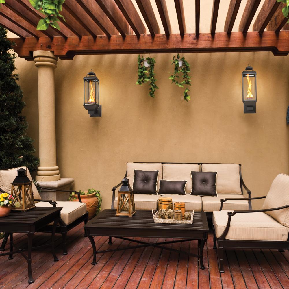 Outdoor gas lantern wall sconce with glass panels and flame, black finish
