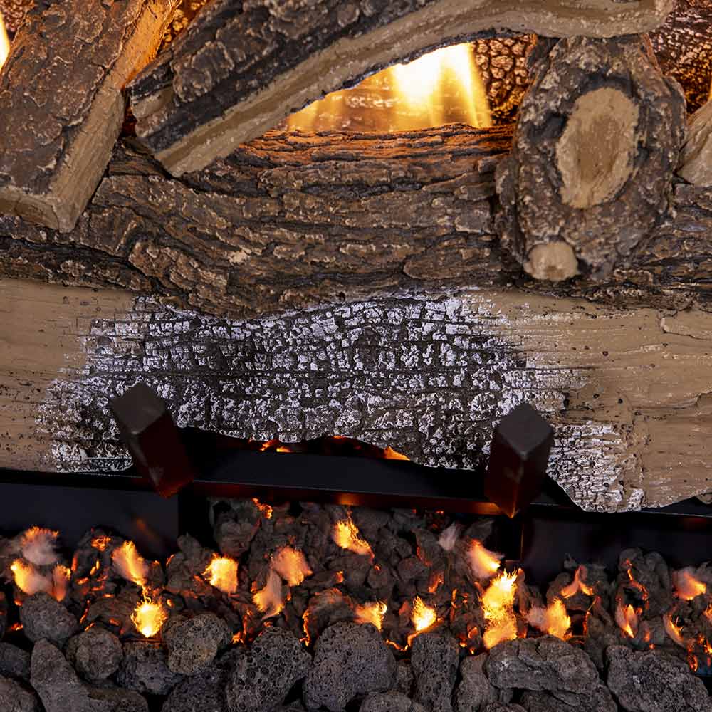 Split oak gas logs with glowing embers and flame peaks inside the firebox
