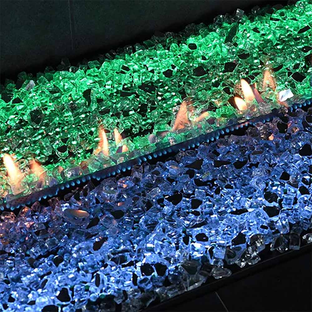 Ventless linear burner with blue and green glass fire bed and visible flames