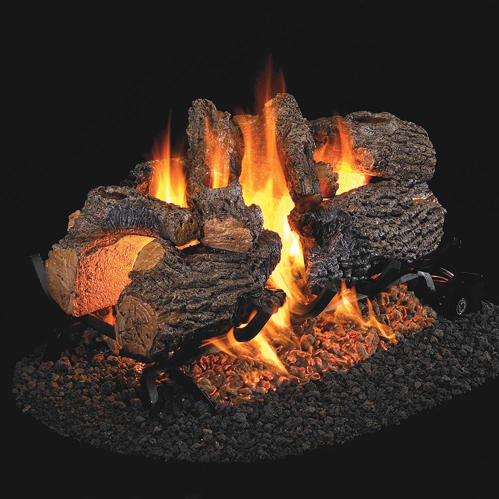 Charred oak vented gas logs set with glowing flames and ember bed
