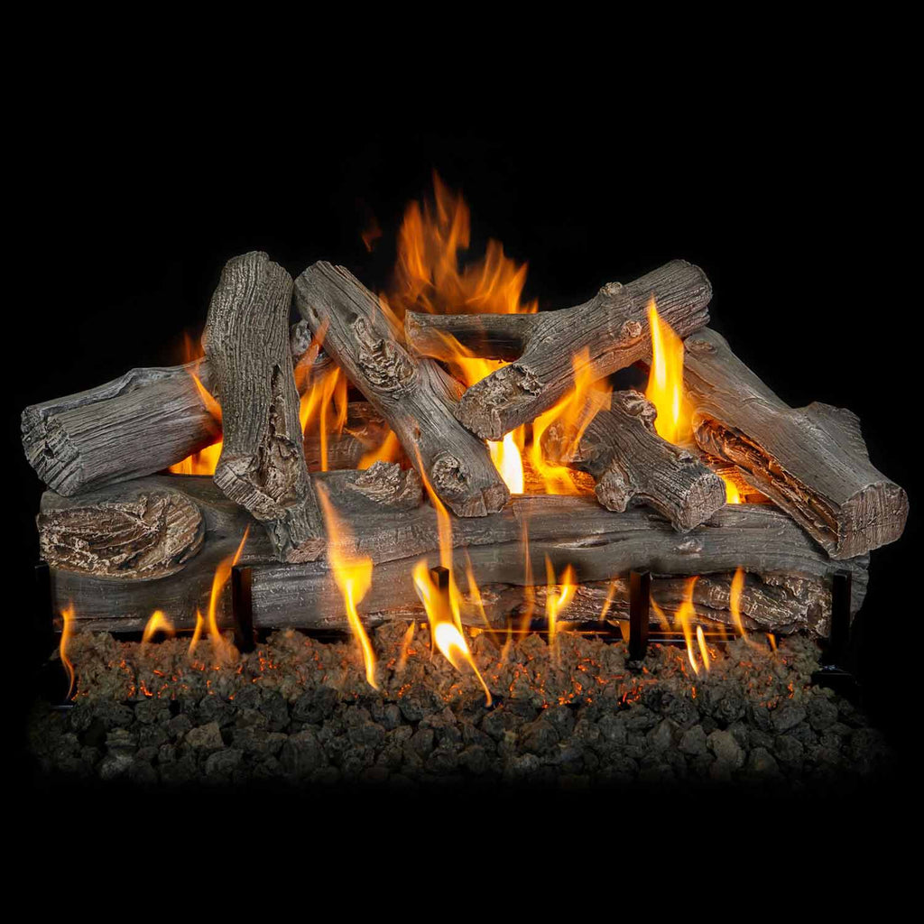 Gas log set with gray driftwood logs, flames rising above fire stones