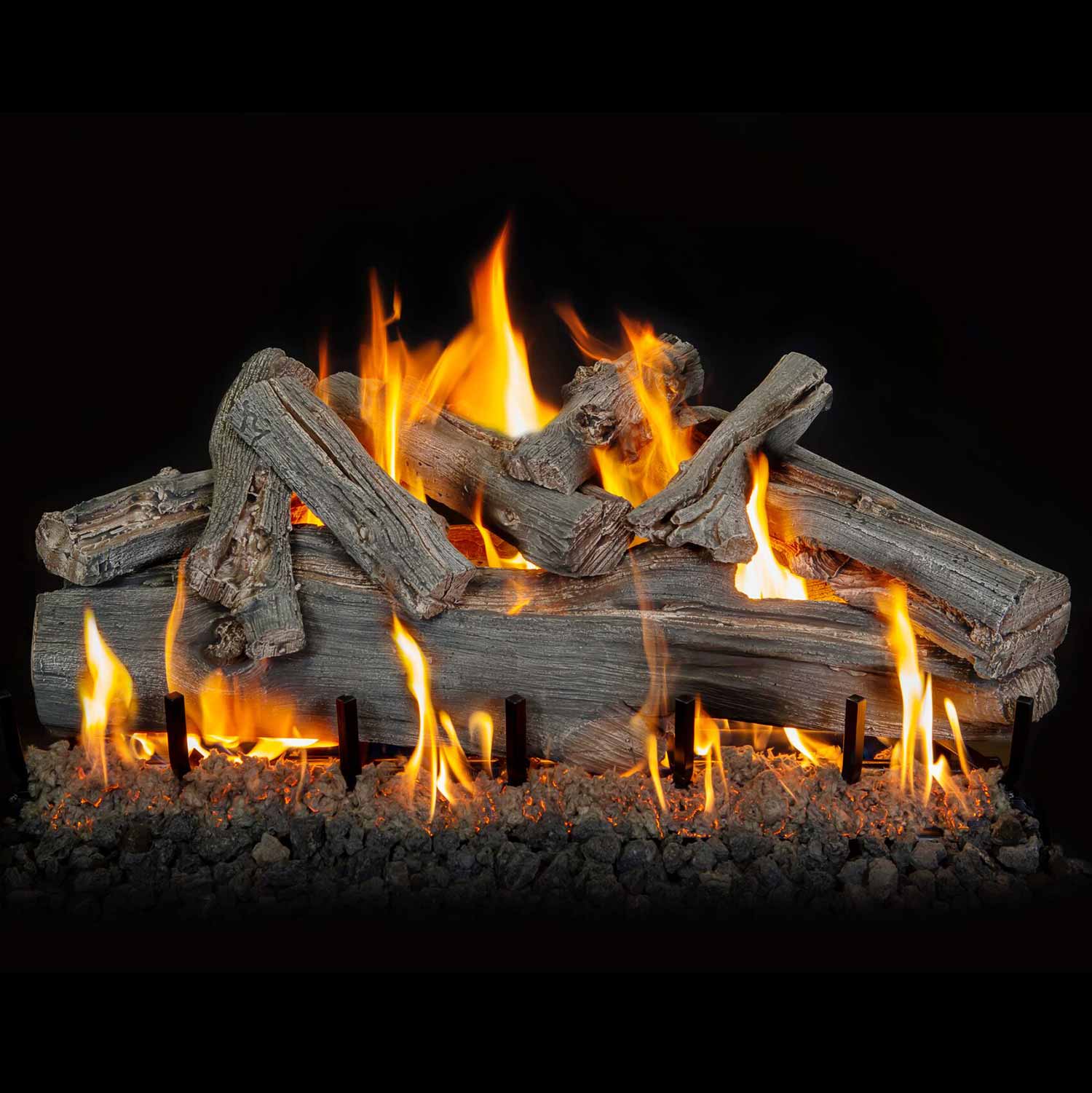 Burning driftwood-style gas logs with bright flames across the log grate