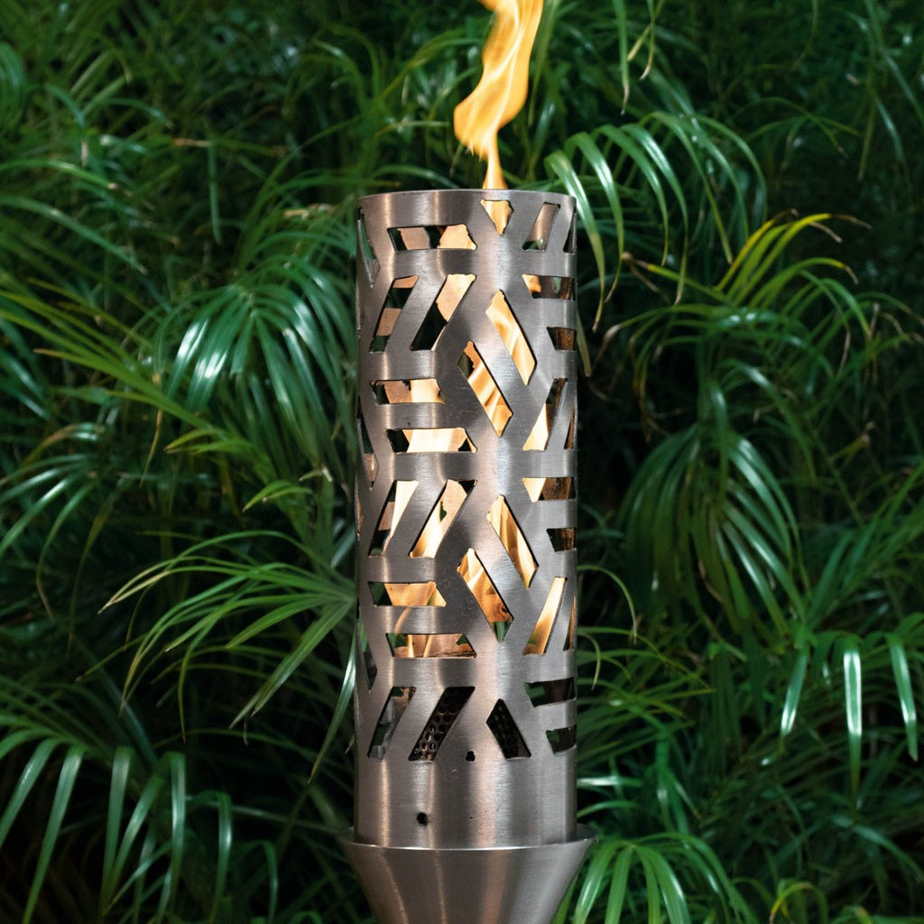 Cubist torch with perforated metal cylinder housing and burning flame