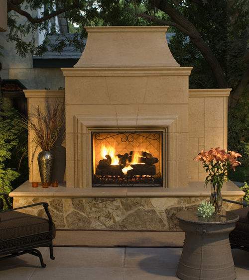 Arched fireplace screen with black frame and scrollwork in front of fire
