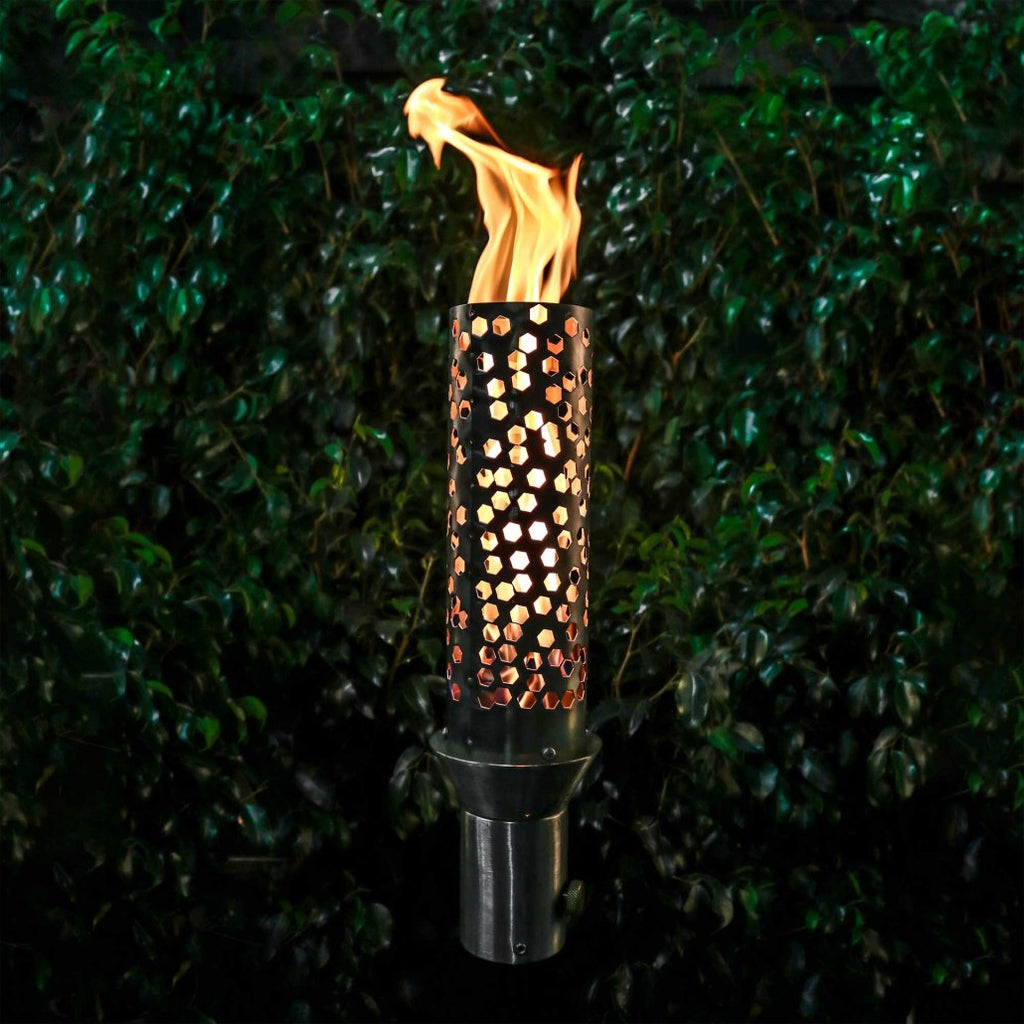 Outdoor torch with perforated honeycomb metal cylinder and burning flame