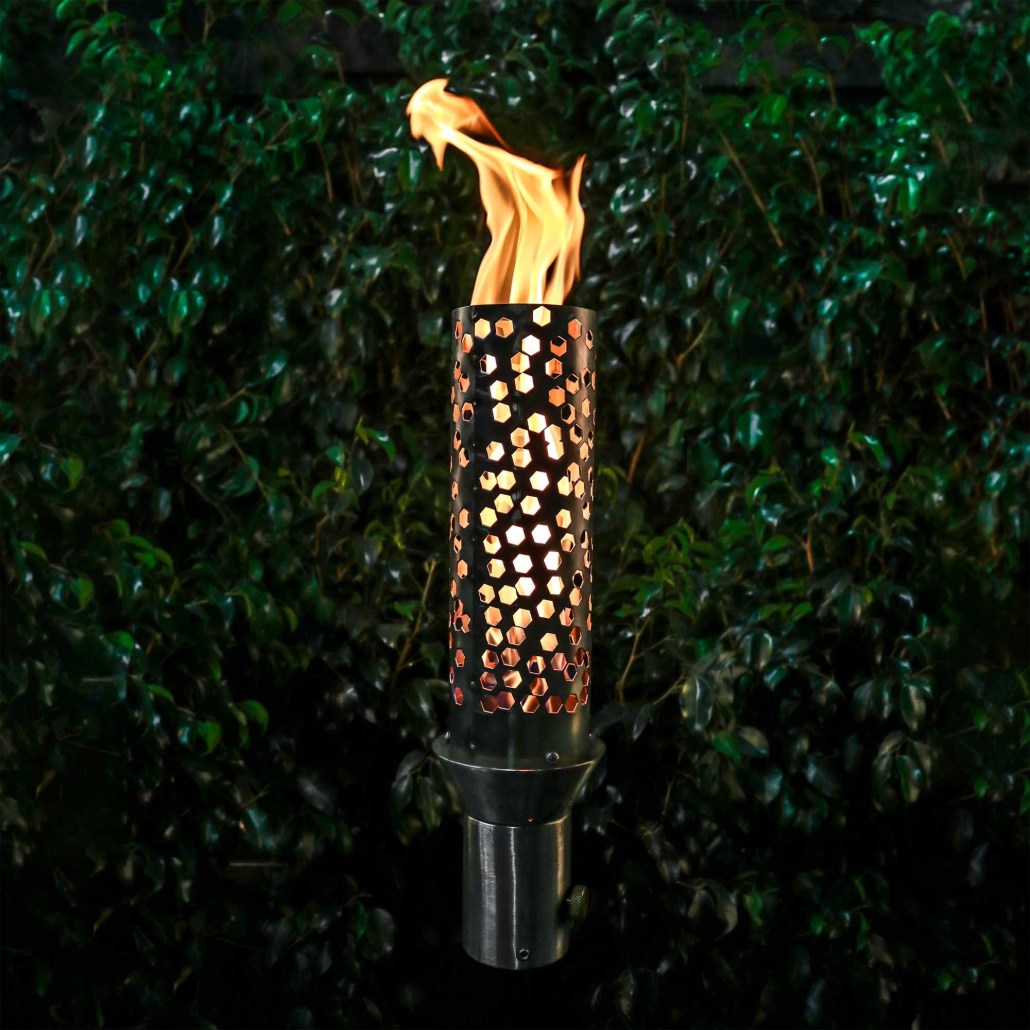 Outdoor torch with perforated honeycomb metal cylinder and burning flame