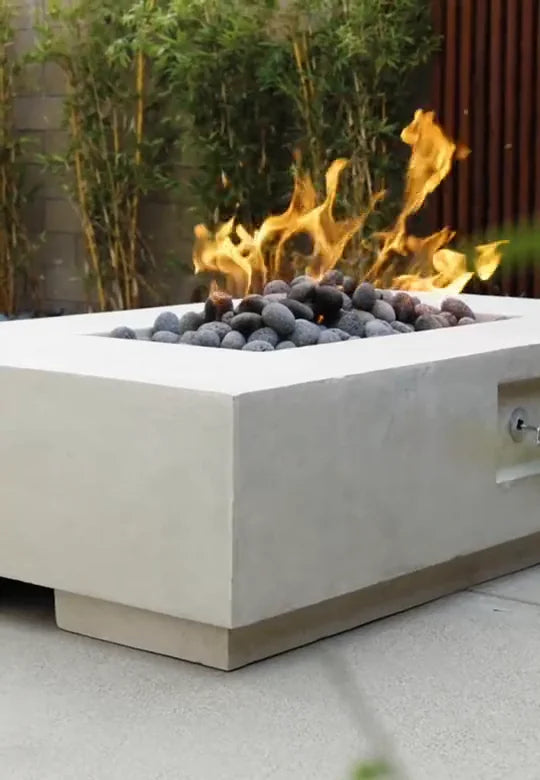 Prism square concrete fire pit with open flame on a modern patio
